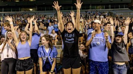 Students cheering and jumping at pep rally.